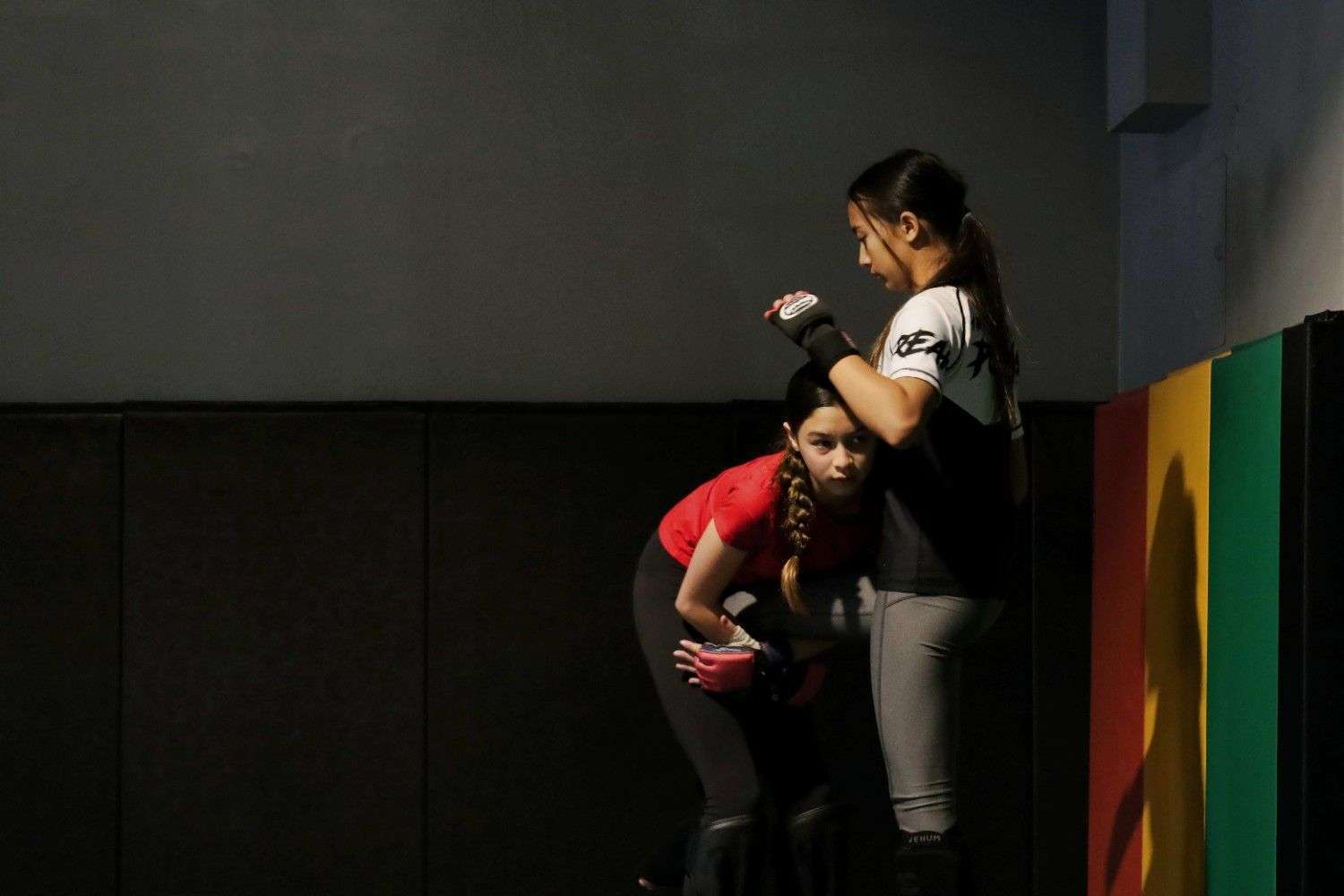 Students practicing grappling techniques on the mat.