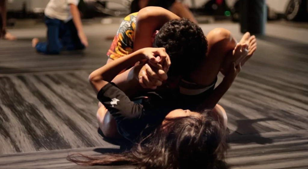 Two youth Jiu Jitsu students practicing ground grappling techniques on the mats at 10th Planet Poway